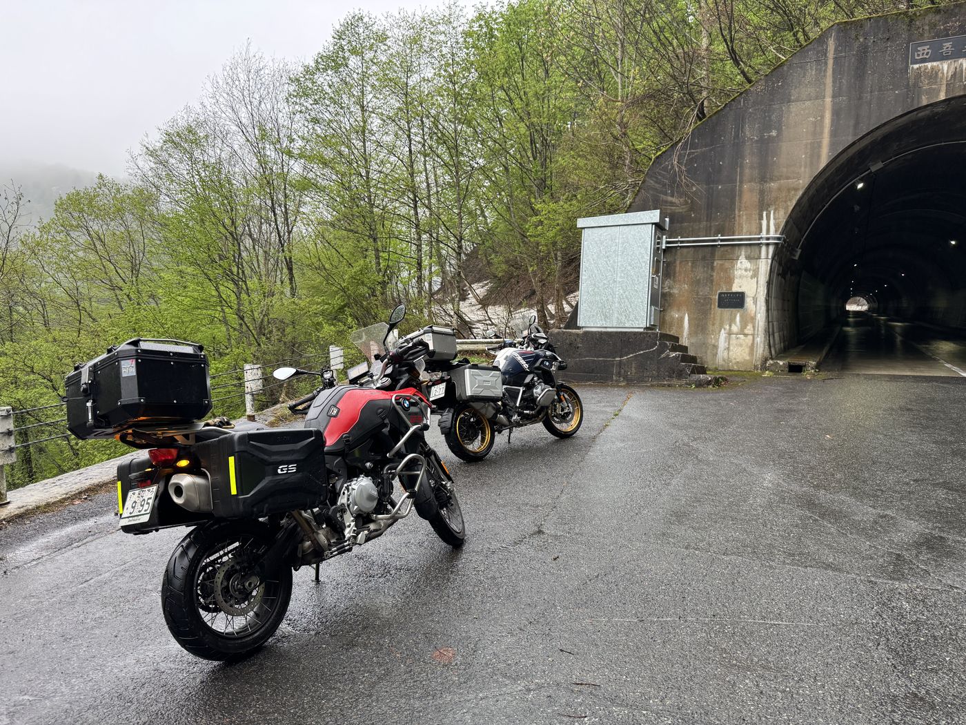 A rainy stop by a mountain tunnel